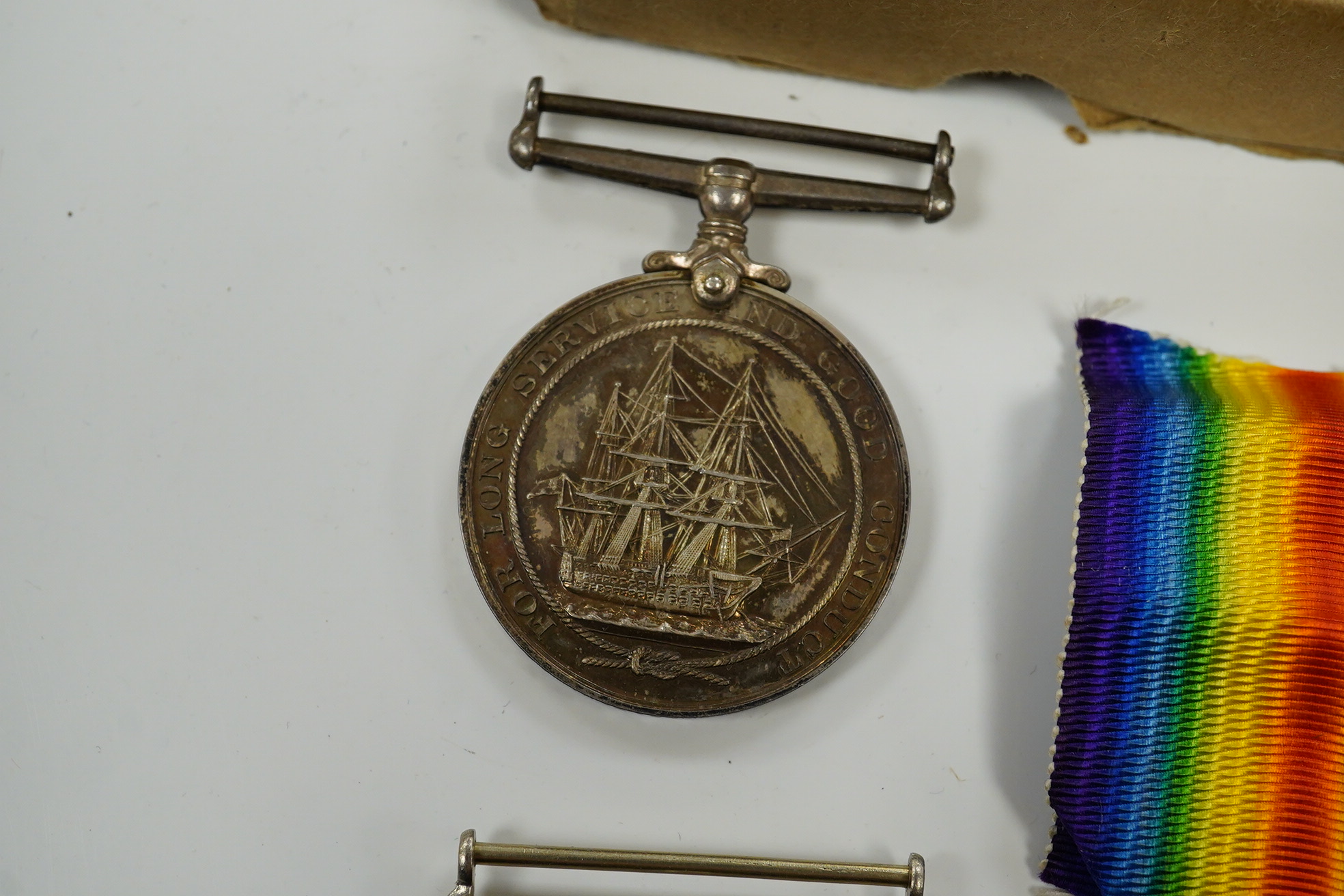 A WWI and WWII medal group awarded to R. Whitham A.B. R.N.; a First World War medal trio with a George V Long Service and Good Conduct Medal, together with a 1939-1945 Medal, the Atlantic Star, and the 1939-1945 Star. Co